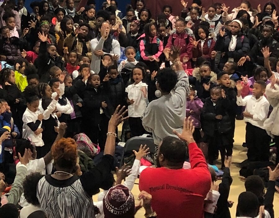 crowd of people raising hands