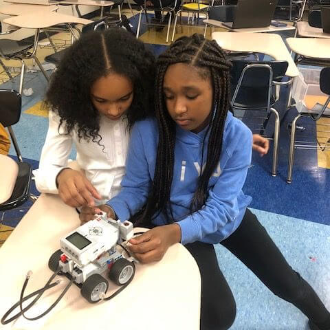 girls working on robot