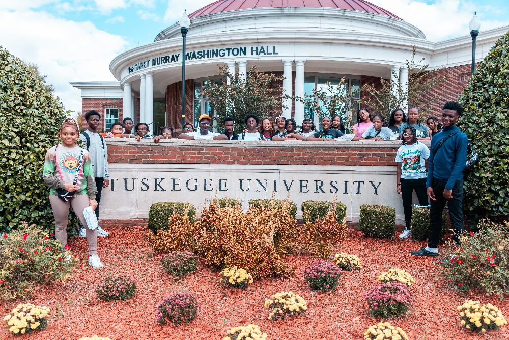 group of kids at tuskegee university sign