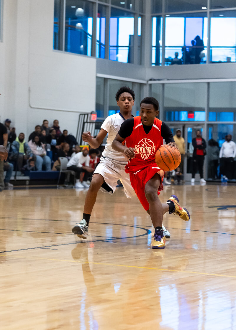 two basketball players from each team going down court