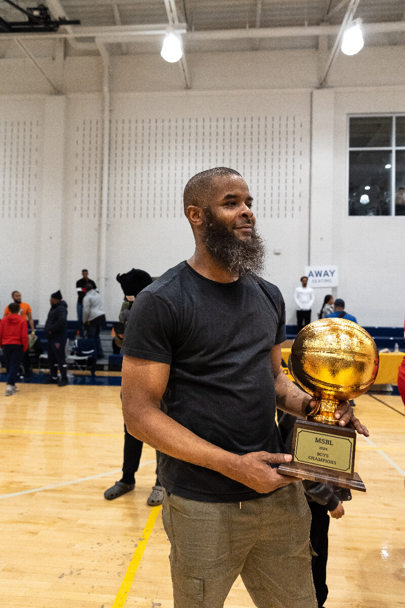 coach holding trophy